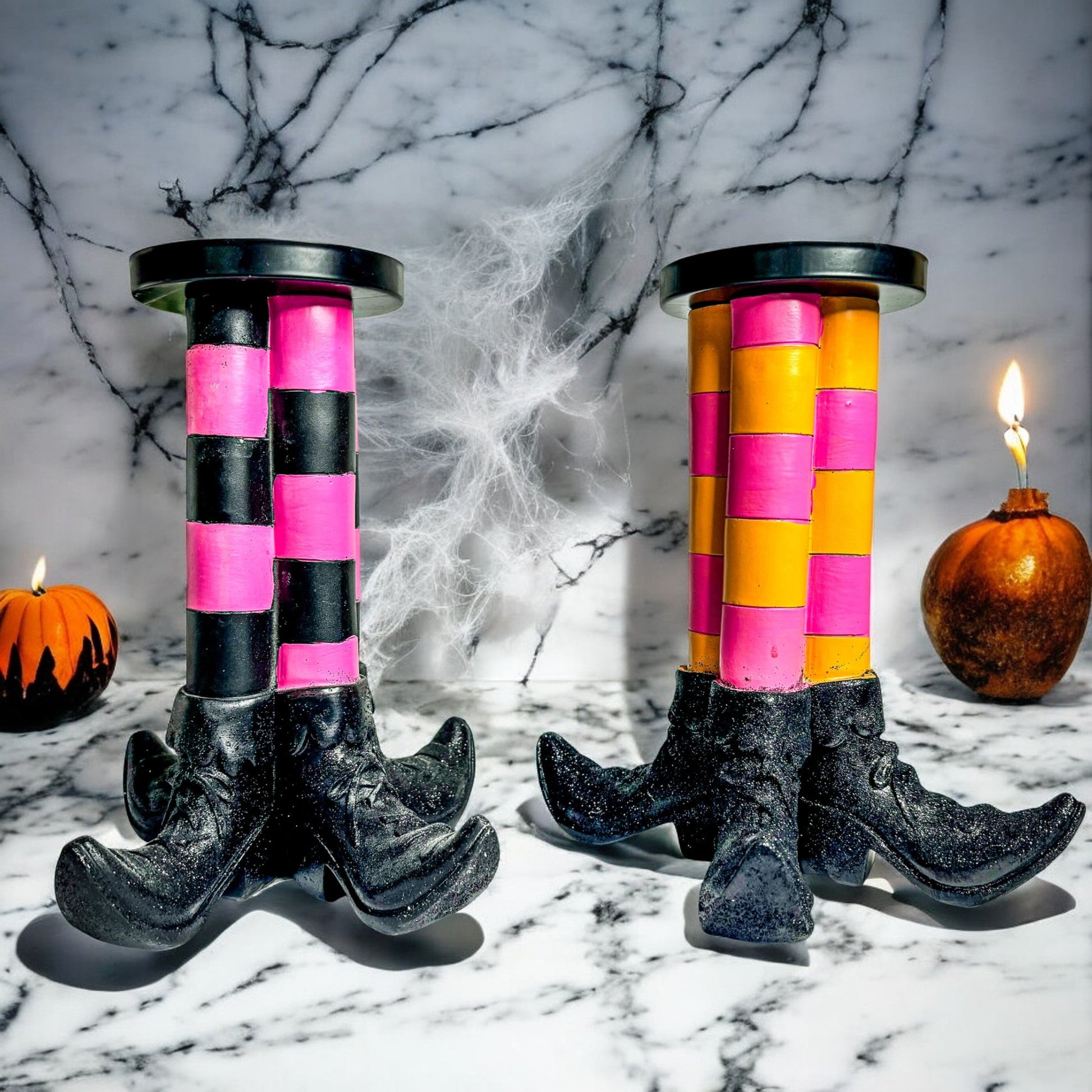 Two Wicked Witch Candle Holders with pink and black striped columns on black boot bases on Tampa Home & Garden Store