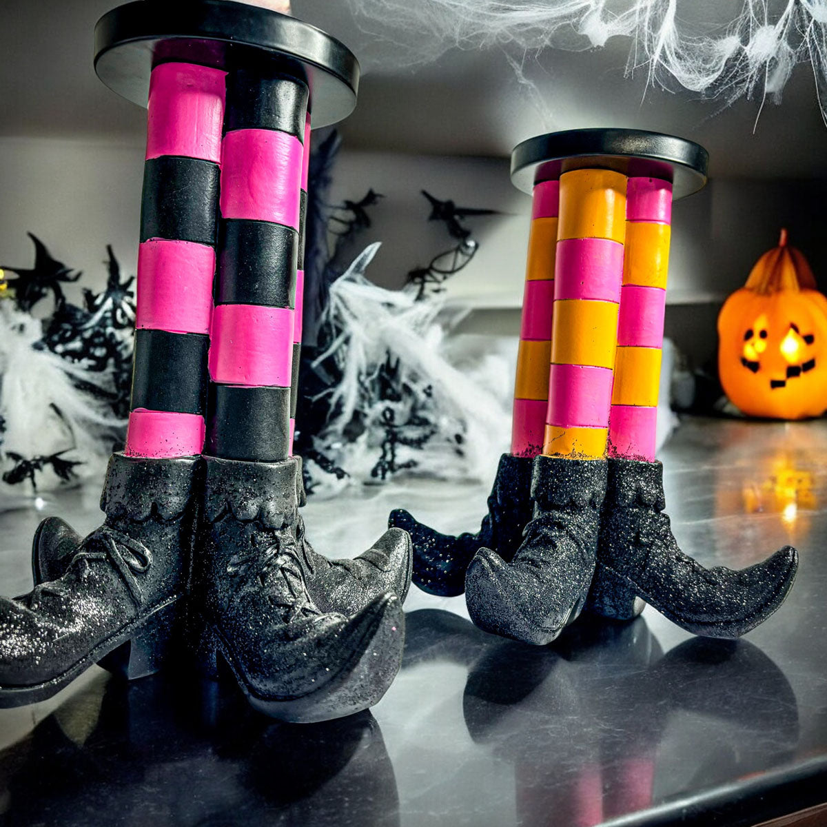 Wicked Witch Candle Holder set by Gia Roma with pink/black and orange/pink striped stockings, boots on Tampa Home & Garden Store