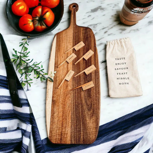 Walnut wooden charcuterie serving board with bamboo markers scattered on top on Tampa Home & Garden Store