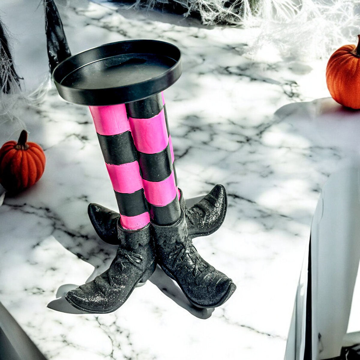 Wicked Witch Candle Holder Gia Roma with pink and black striped legs and black boots on Tampa Home & Garden Store