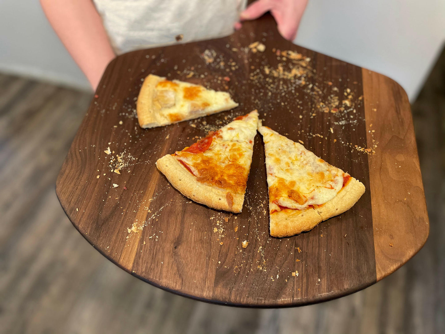 Walnut pizza peel 22x16 in wooden pizza board with sliced pizza on top on Tampa Home & Garden Store