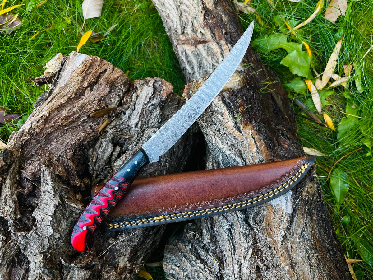 Damascus steel custom flay knife TK-051 with craved grips and leather sheath on log on Tampa Home & Garden Store