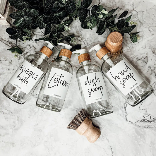 Four 16oz clear glass dispensers with white labels and wood pump tops by Gia Roma on Tampa Home & Garden Store