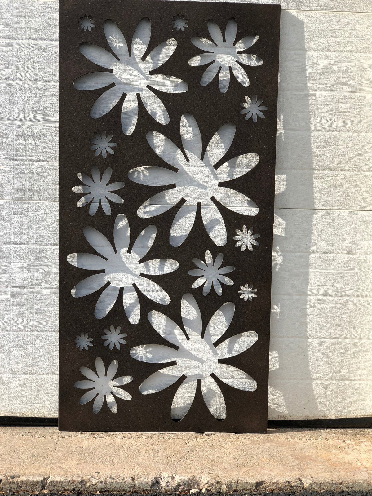 Decorative metal privacy screen panel with large floral cutouts in dark brown finish on Tampa Home & Garden Store