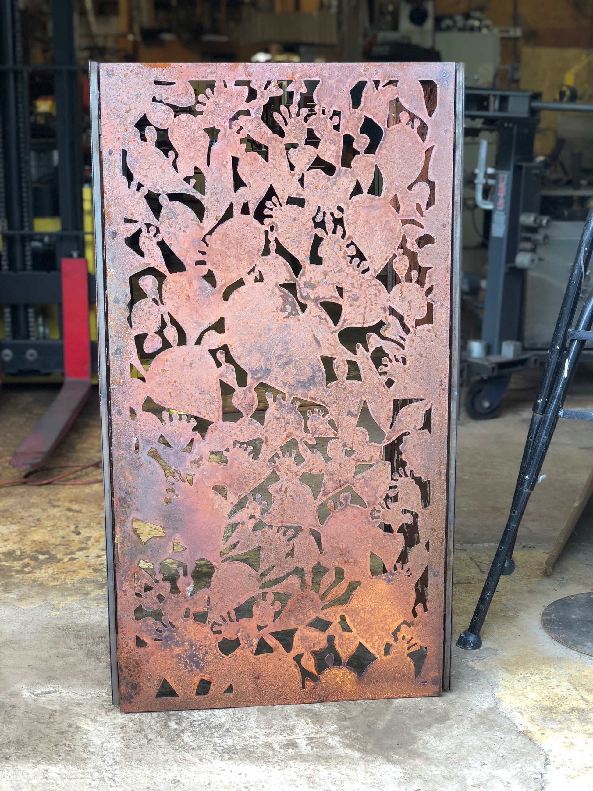 Outdoor privacy panel by Rustica Ornamentals in rusted steel with intricate floral cutouts on Tampa Home & Garden Store