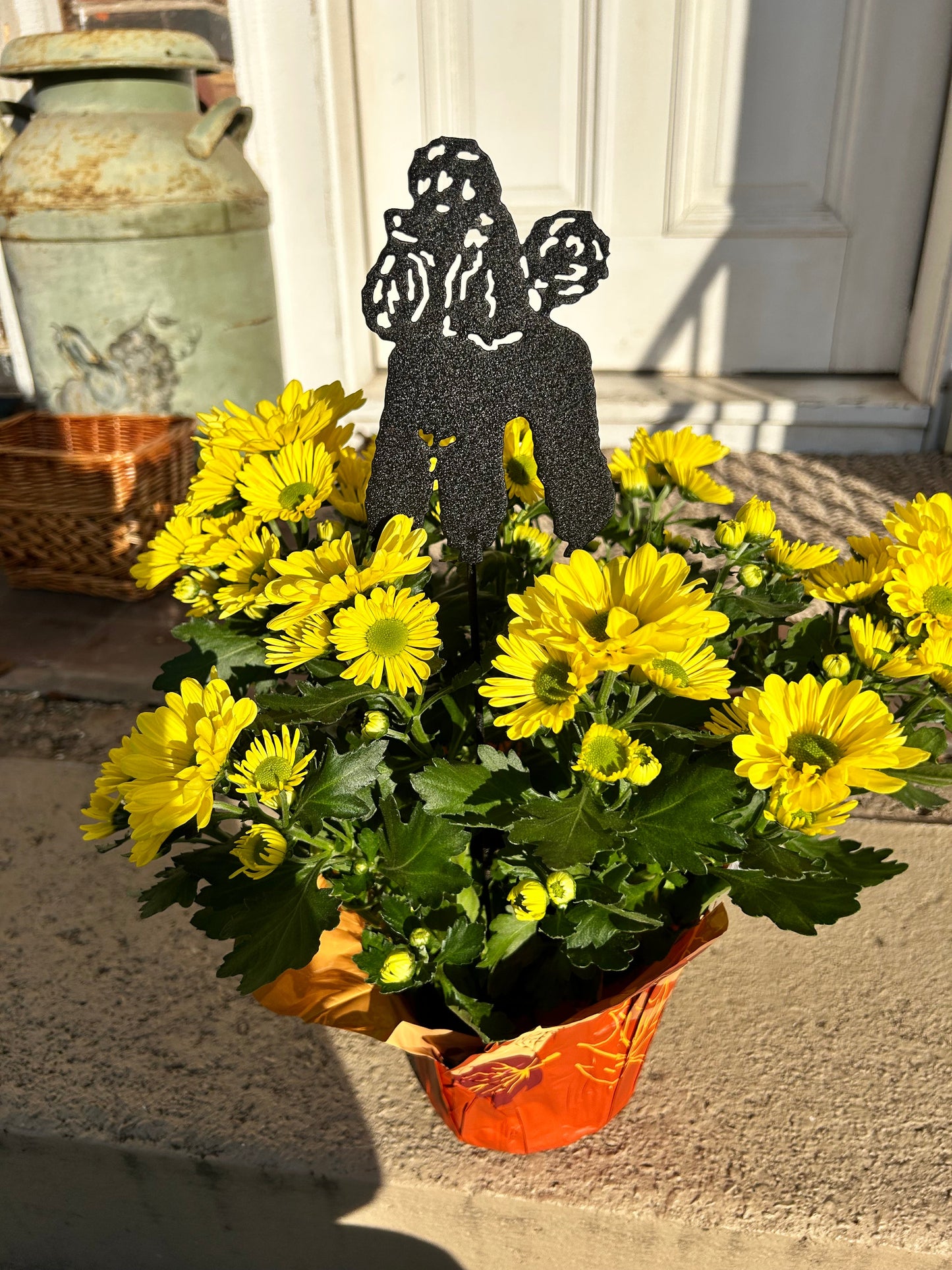 Poodle ornament plant stake in black metal by Rustica Ornamentals among yellow mums on Tampa Home & Garden Store