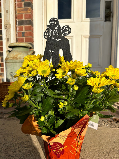 Poodle plant stake ornament, black metal dog memorial by Rustica Ornamentals amid yellow mums on Tampa Home & Garden Store