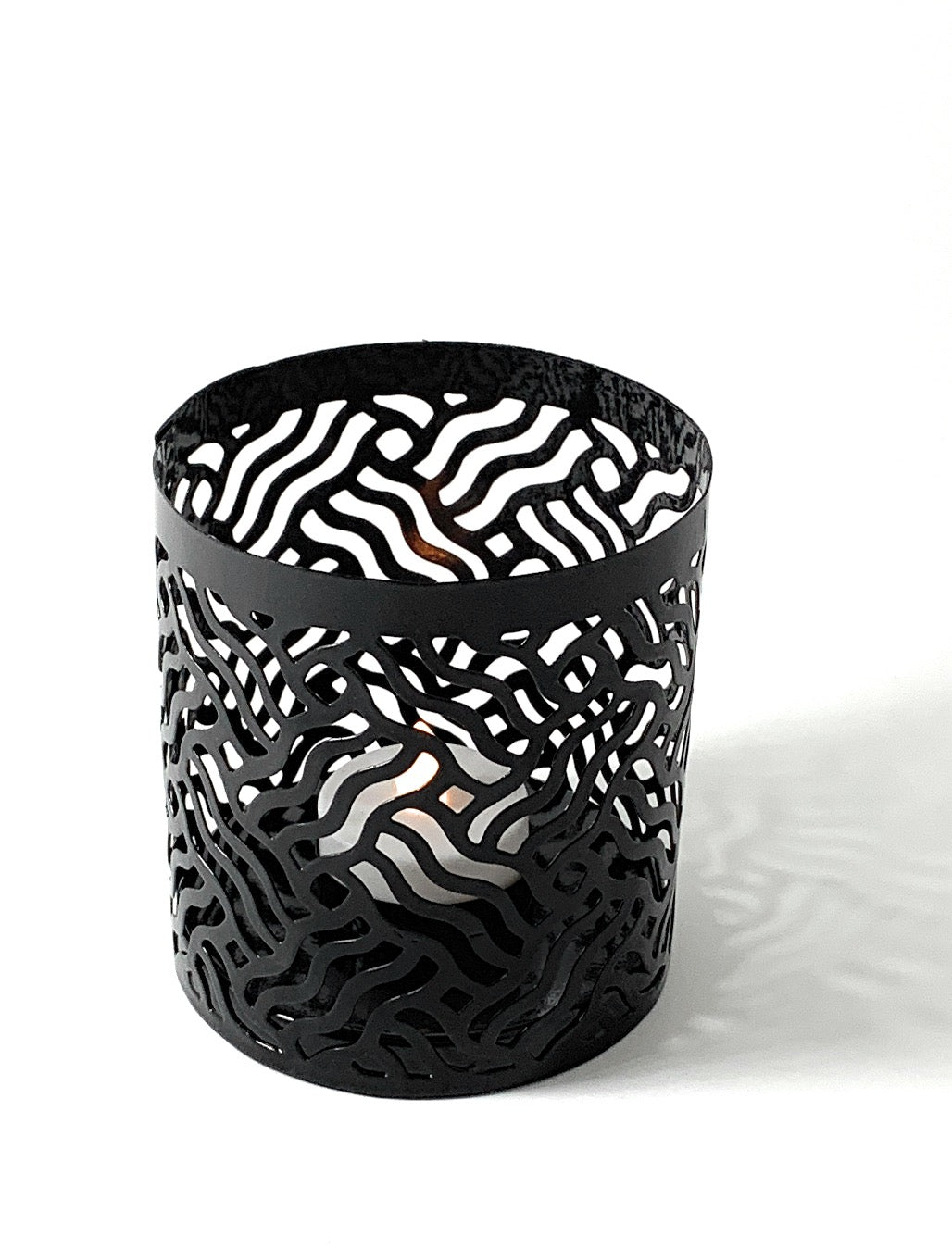 Vibhsa black laser-cut votive candle holder with intricate wavy pattern on Tampa Home & Garden Store