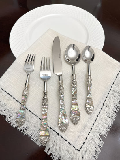 Vibhsa 20-piece stainless steel flatware set with Seawork handles on a beige napkin on Tampa Home & Garden Store