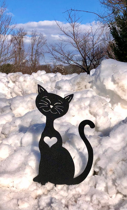 Cat garden art silhouette in black, metal yard sculpture with heart cutout amid snow on Tampa Home & Garden Store