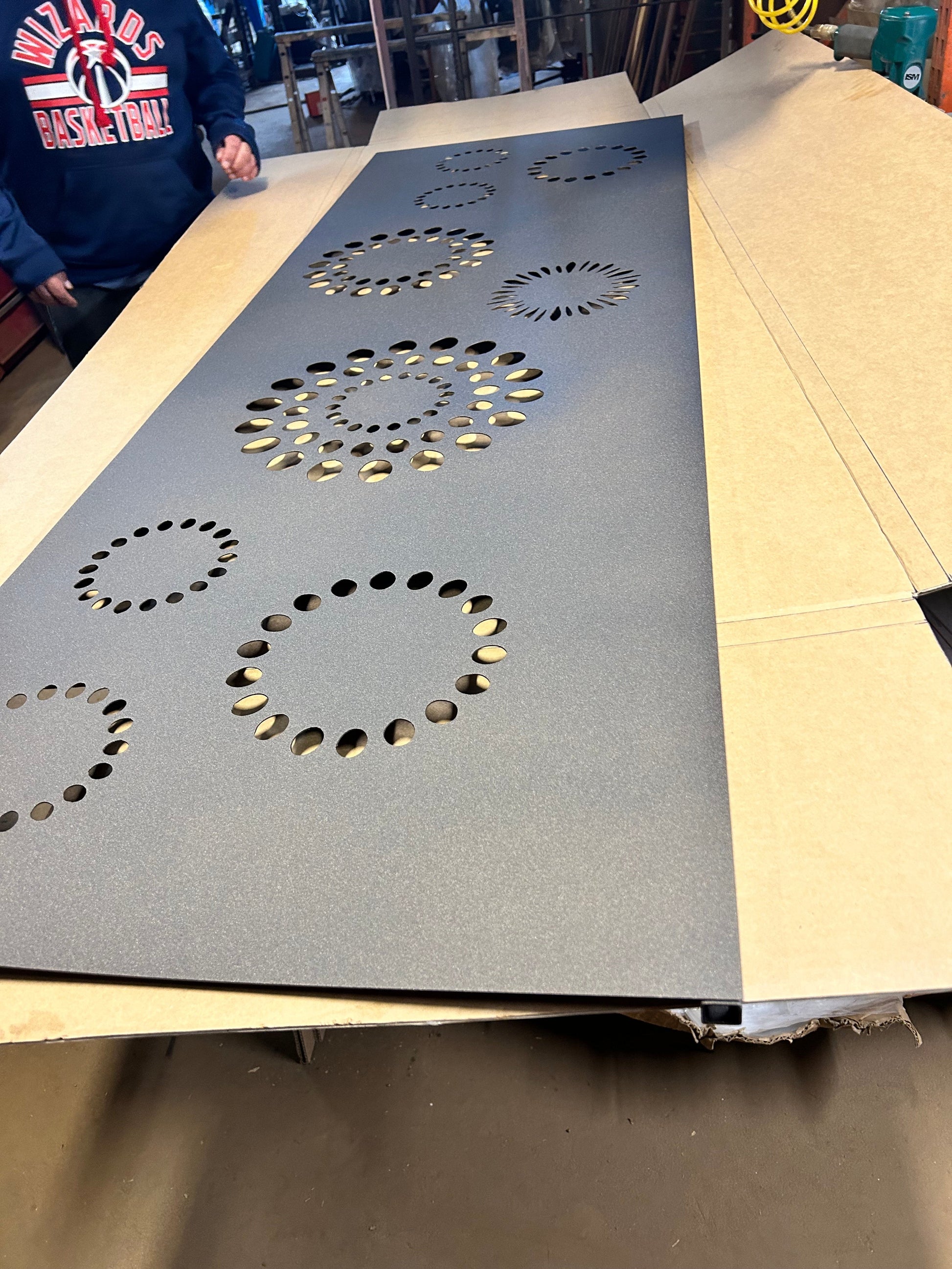 Outdoor gray metal privacy panel with circular perforations by Rustica Ornamentals on Tampa Home & Garden Store
