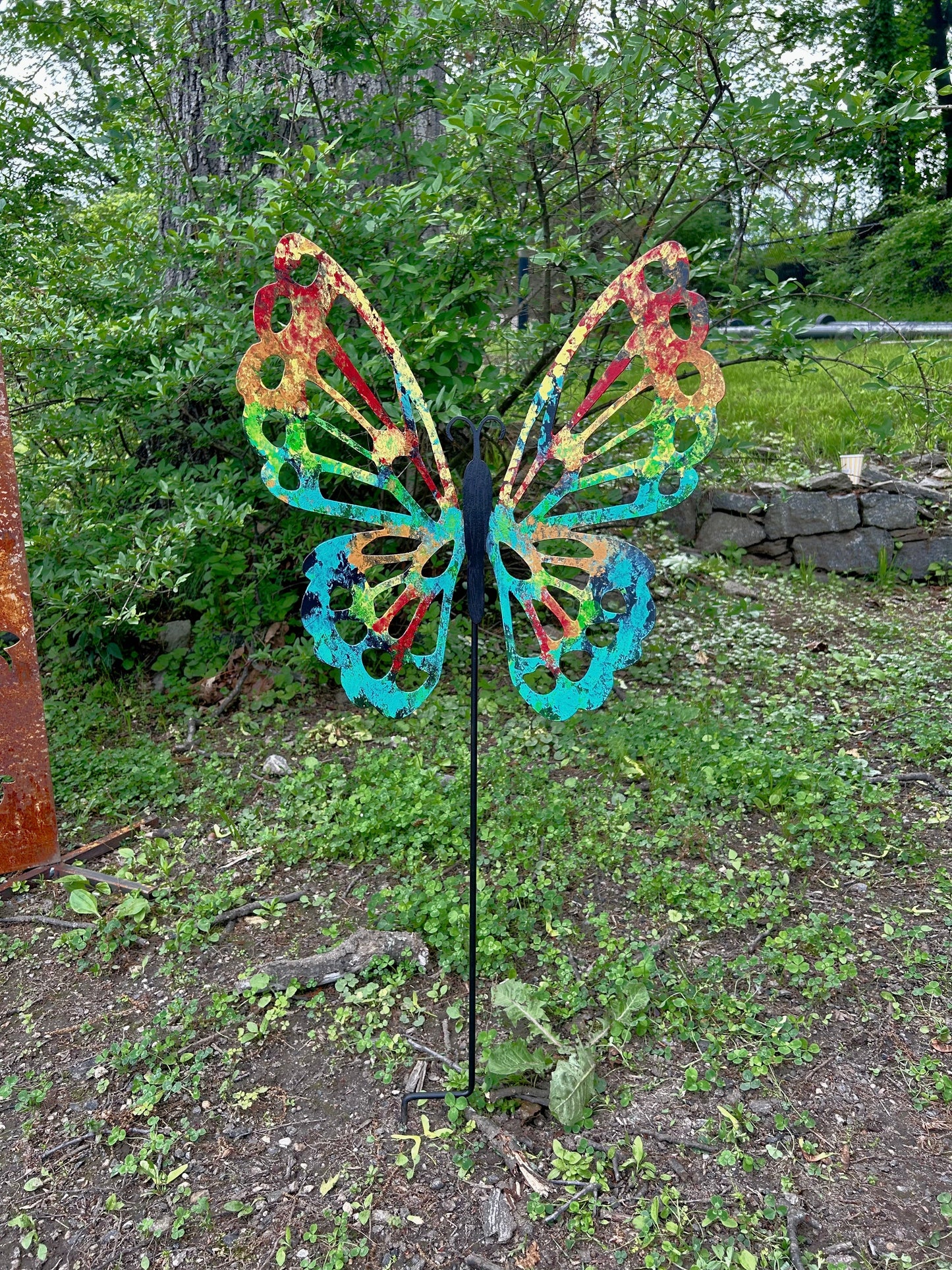 Metal butterfly garden stake with rainbow wings, rust accents on Tampa Home & Garden Store