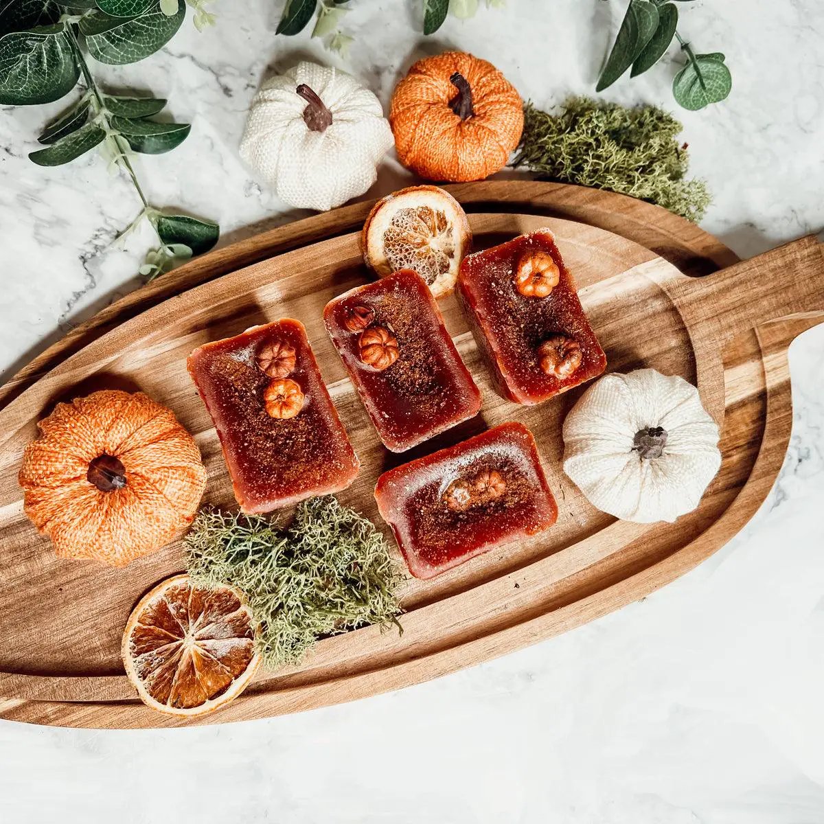 Gia Roma Pumpkin Buttercream Wax Melts Cinnamon Pie five orange-brown wax tarts on a wooden board on Tampa Home & Garden Store