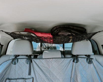 Toyota Tacoma Attic Storage Net by Flatirons Overland; black elastic cargo net with red blanket and black jacket on Tampa Home & Garden Store
