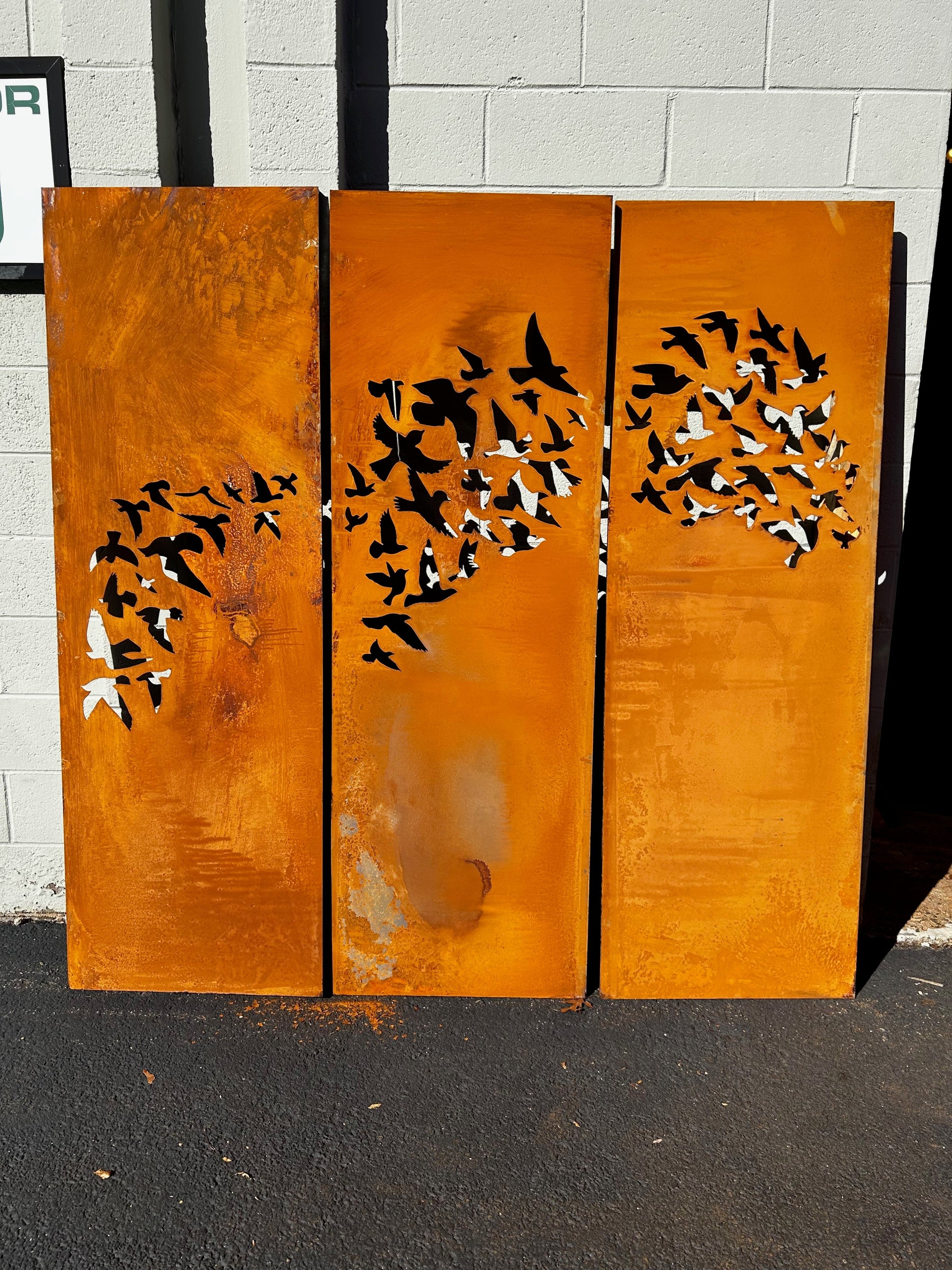 Outdoor metal privacy fence panels in rust-orange with bird silhouettes, 3-panel set on Tampa Home & Garden Store