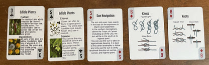 Life in a Pack Survival Playing Cards deck by River Country Gear; five cards show edible plants, sun navigation, and knots on Tampa Home & Garden Store
