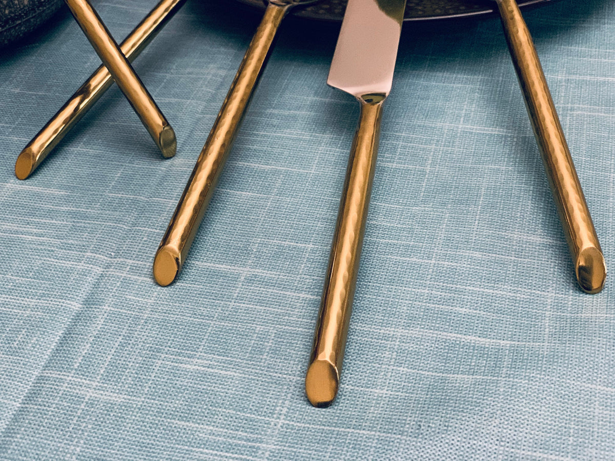 Vibhsa flatware set 30pc gold-tone on blue fabric backdrop on Tampa Home & Garden Store