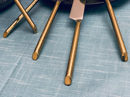 Vibhsa flatware set 30pc gold-tone on blue fabric backdrop on Tampa Home & Garden Store