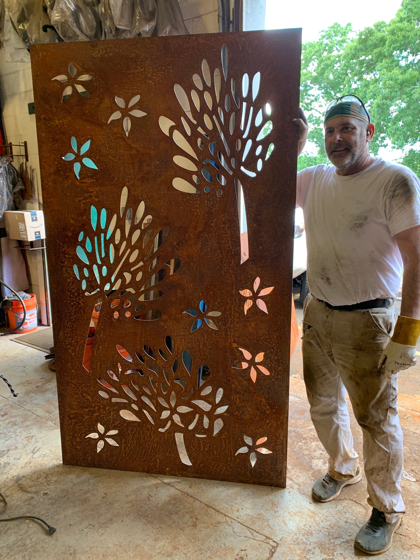 Outdoor metal privacy screen panel in rust finish with floral cutouts by Rustica Ornamentals on Tampa Home & Garden Store