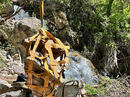 Rock Hammock with orange nylon straps by Backslope Tools on rugged rocky waterfall site on Tampa Home & Garden Store