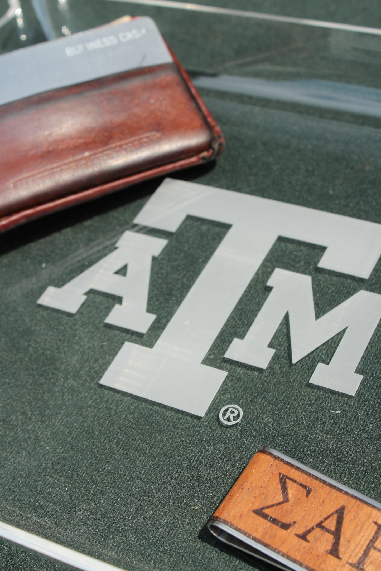 Texas A&M University acrylic tray by Ryan's Woodworking with branded metal edge on a dark green surface on Tampa Home & Garden Store