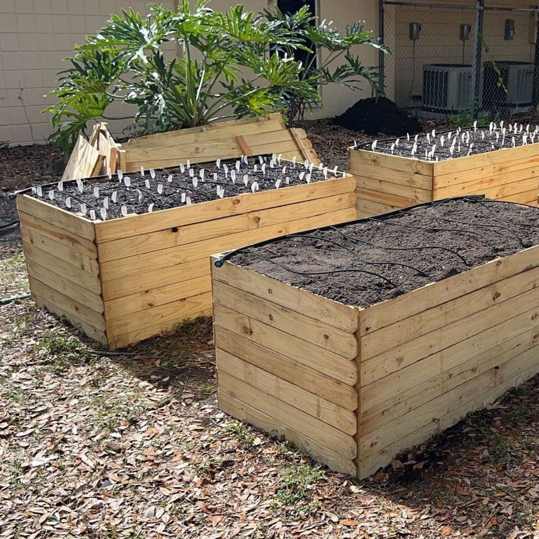 4 pressure treated raised garden beds installed at your location.
