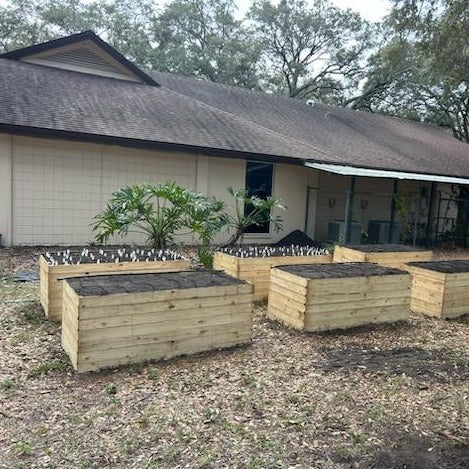 ^ wood garden beds installed in rows. Includes soil and irrigation and pressure treated wood.