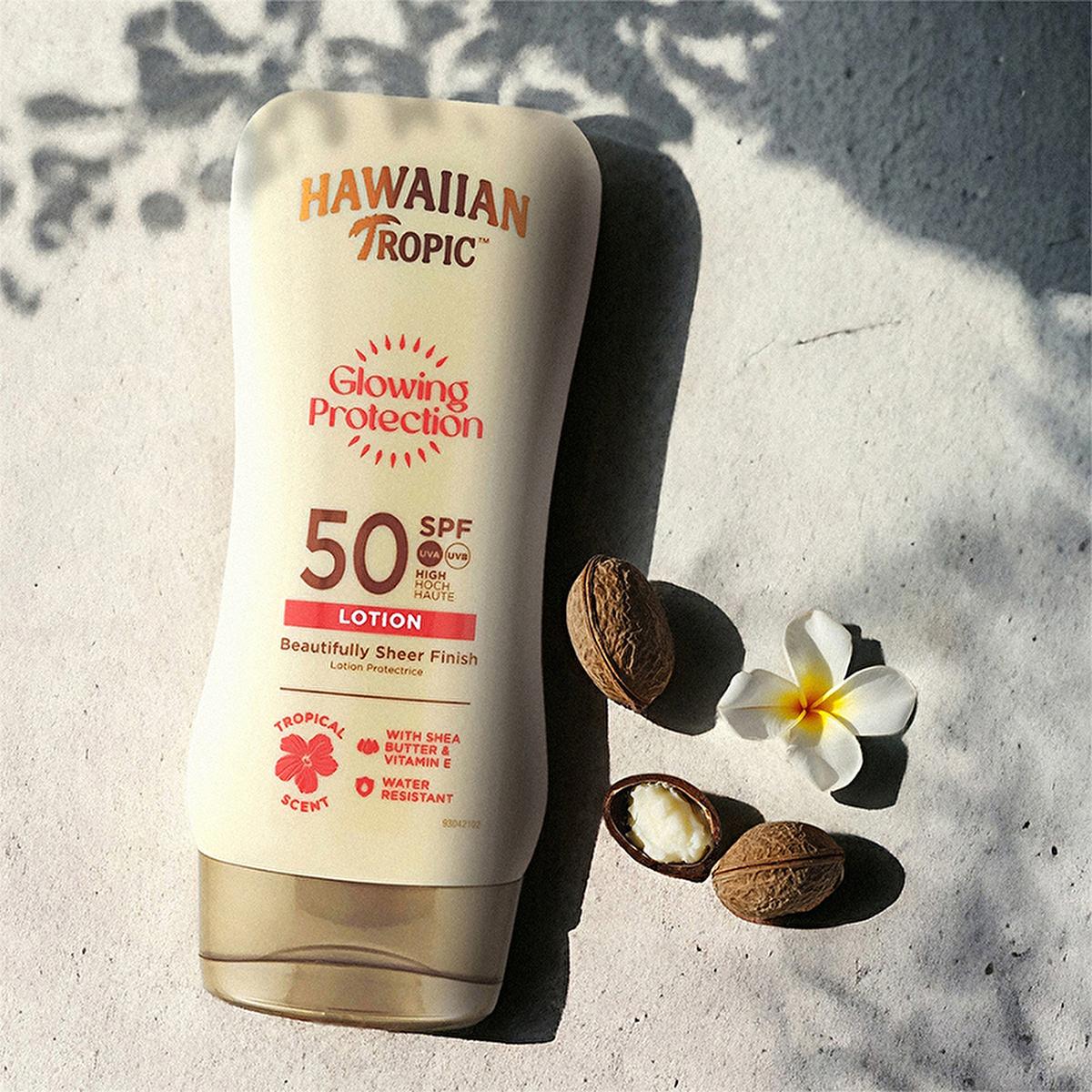 Hawaiian Tropic Glowing Protection SPF 50 sunscreen lotion pale cream bottle on sandy surface on Tampa Home & Garden Store