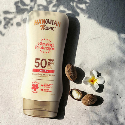 Hawaiian Tropic Glowing Protection SPF 50 sunscreen lotion pale cream bottle on sandy surface on Tampa Home & Garden Store