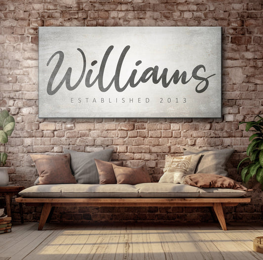 Family Name Sign IV canvas with a black cursive surname on a textured backdrop brick wall on Tampa Home & Garden Store