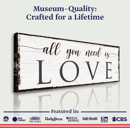 All You Need Is Love canvas sign on whitewashed wood with dark frame Tailored Canvases on Tampa Home & Garden Store.