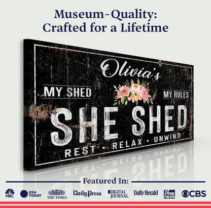 Canvas sign IX: Personalized She Shed on a black distressed board with floral bouquet on Tampa Home & Garden Store