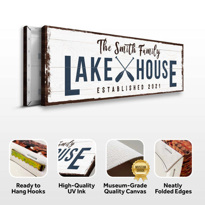 Family Lake House Arrow Sign II canvas on rustic whitewashed planks with navy lettering and crossed paddles Tailored Canvases on Tampa Home & Garden Store