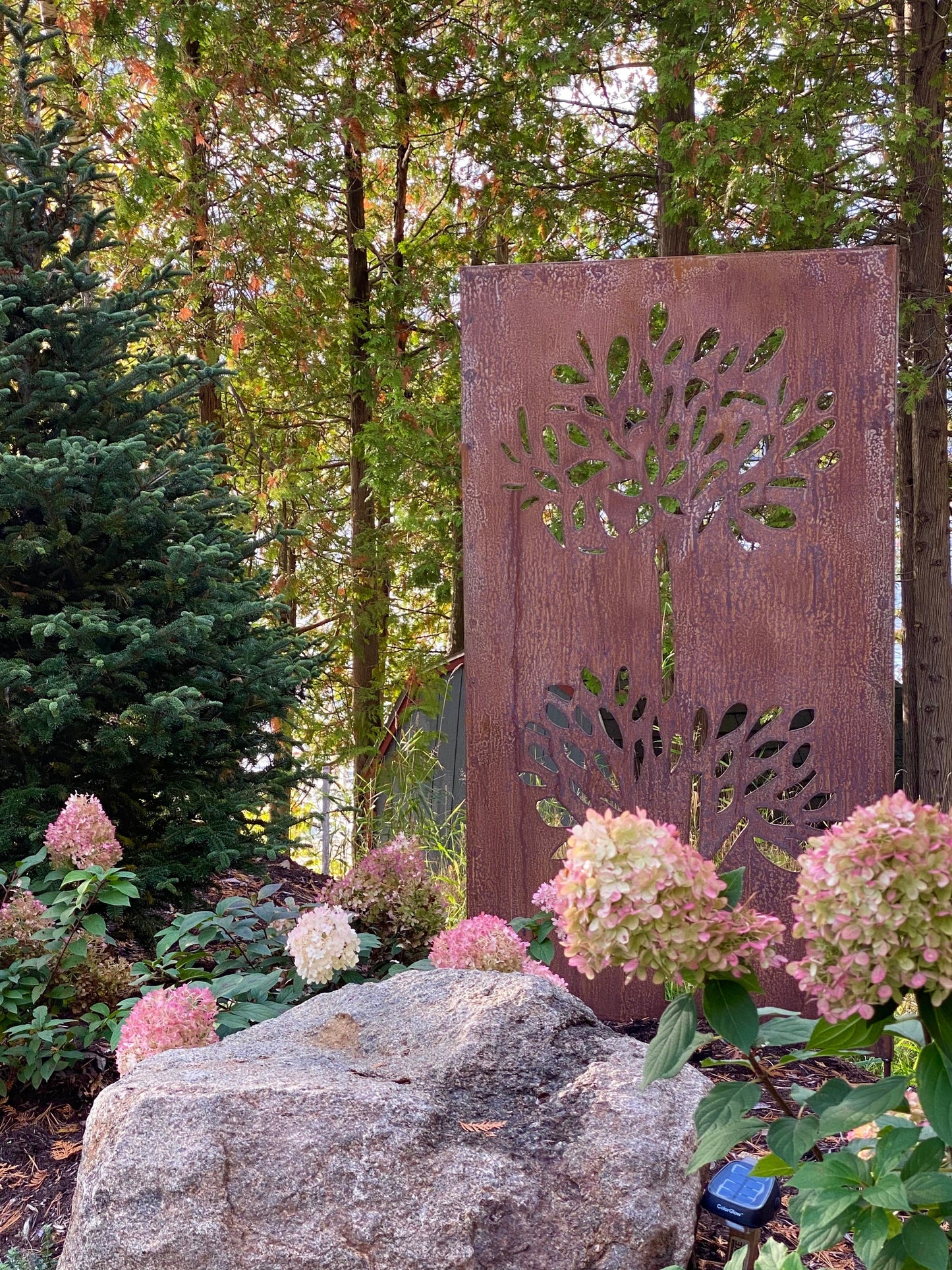 Outdoor rust-colored metal privacy screen panel with leaf-cutout motif by Rustica Ornamentals on Tampa Home & Garden Store