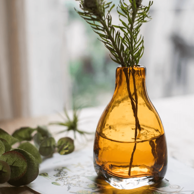 Amber handblown glass vase by RusticReach with leafy stems on Tampa Home & Garden Store