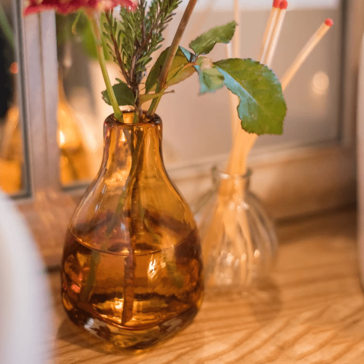 Amber handblown glass vase with greenery; two vases visible in background RusticReach on Tampa Home & Garden Store