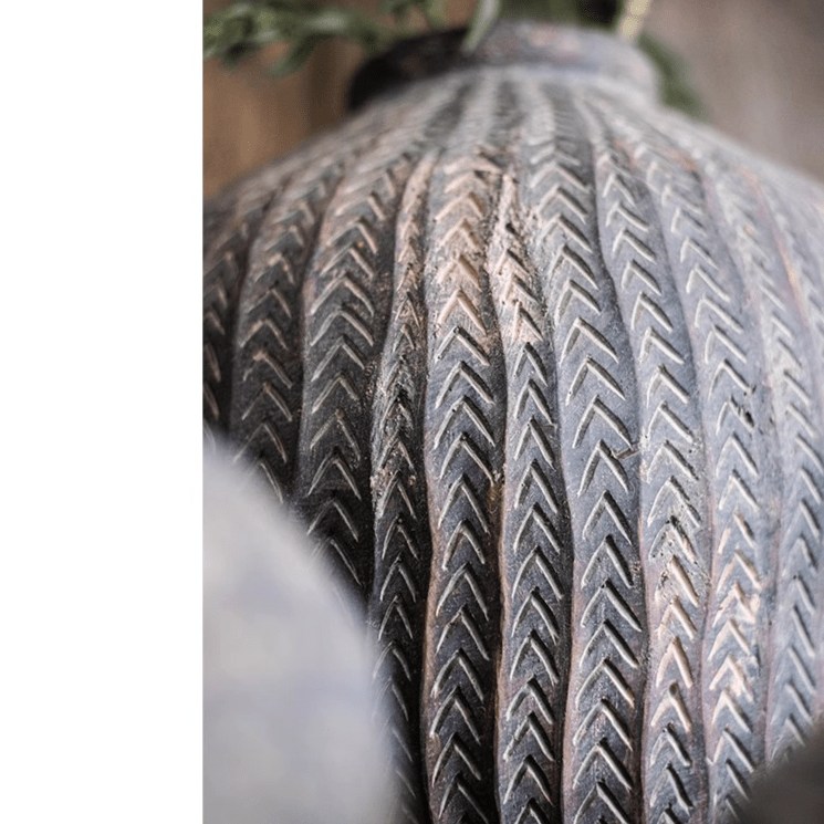 Tire tread close-up with chevron grooves in weathered rubber on Tampa Home & Garden Store