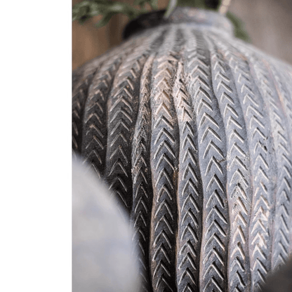 Tire tread close-up with chevron grooves in weathered rubber on Tampa Home & Garden Store