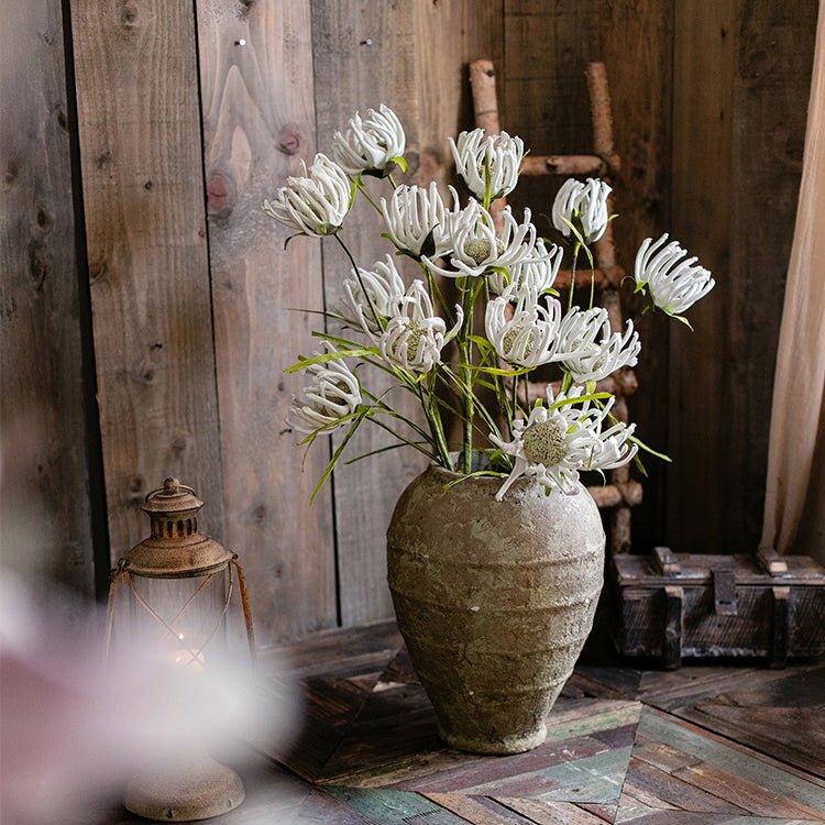 Faux silk white art sunflower stems bouquet in a weathered ceramic vase on rustic display on Tampa Home & Garden Store