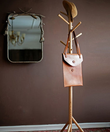Ash wood coat rack by RusticReach with brown leather bag and straw hat in entryway on Tampa Home & Garden Store