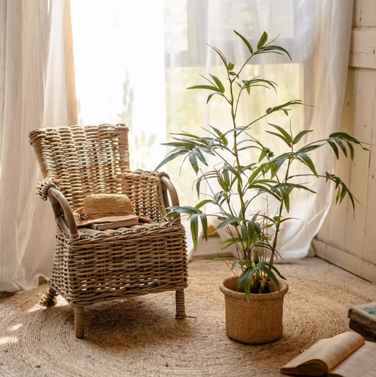 Artificial Bamboo Leaves in Pot green faux bamboo plant in woven planter beside wicker chair on Tampa Home & Garden Store