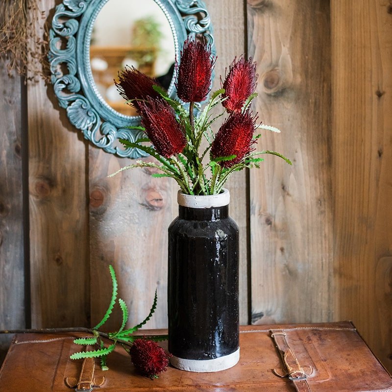 RusticReach faux Banksia Integrifolia arrangement in a tall black vase with white rim, red blooms on Tampa Home & Garden Store