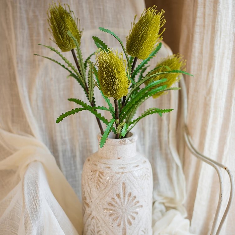 Faux Banksia Integrifolia flower stems in a beige ceramic vase with 4 yellow-green blooms on Tampa Home & Garden Store