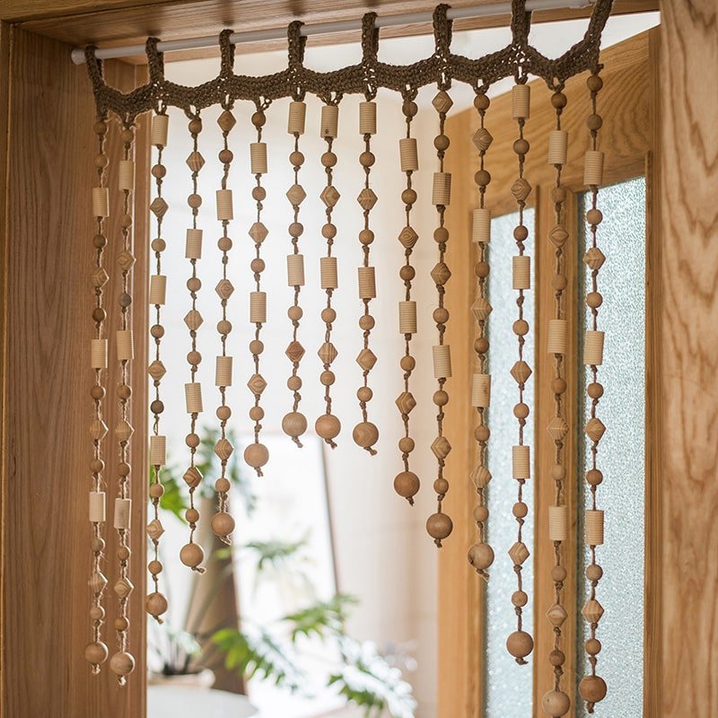 Wood Beaded Door Curtain with natural wood beads and geometric shapes hanging in a doorway on Tampa Home & Garden Store