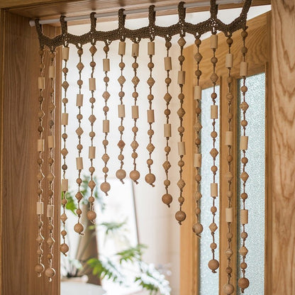Wood Beaded Door Curtain with natural wood beads and geometric shapes hanging in a doorway on Tampa Home & Garden Store