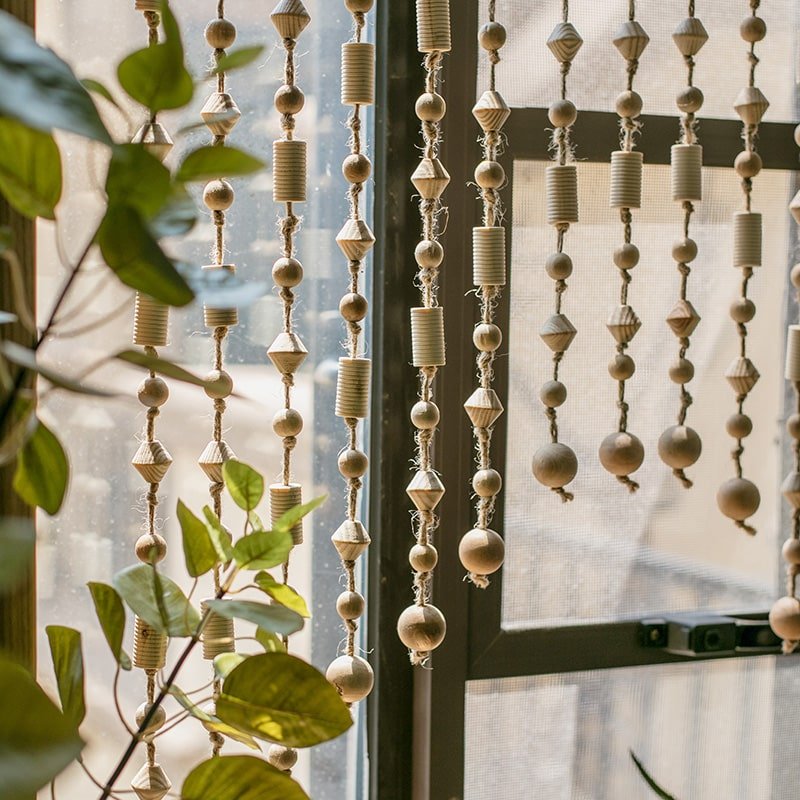 Wood beaded door curtain RusticReach with natural beige wood beads, few bead strands by window on Tampa Home & Garden Store