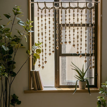 Wood Beaded Door Curtain by RusticReach natural wood beads draped over a window on Tampa Home & Garden Store