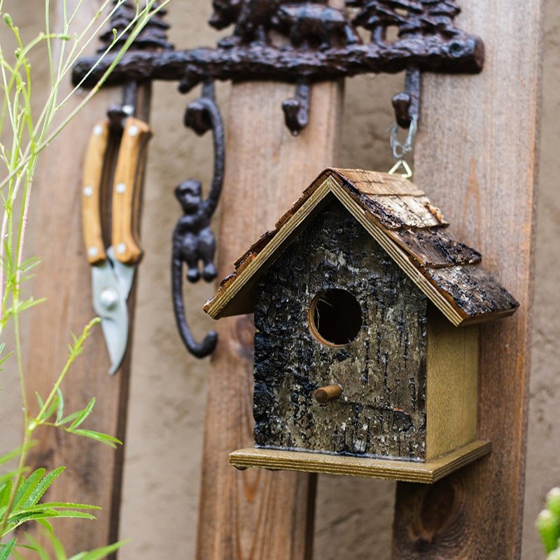 Birch Wood Decorative Bird House by RusticReach, weathered bark exterior, hanging on fence on Tampa Home & Garden Store