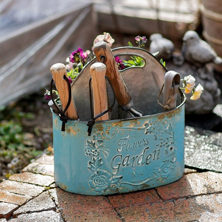 Blue metal tool basket with three wood-handled garden tools RusticReach embossing on Tampa Home & Garden Store