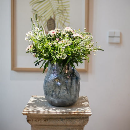 Blue bubble hand blown glass vase by RusticReach holding a bouquet of white daisies and greenery on Tampa Home & Garden Store
